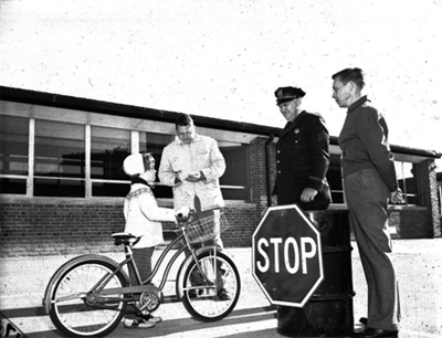 child on bike with police officers