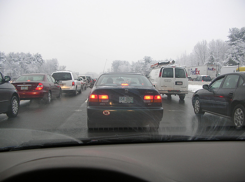 Car in a traffic jam on a snowy highway
